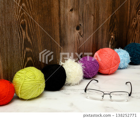 ruler made of wool balls and black glasses on marble 138252771