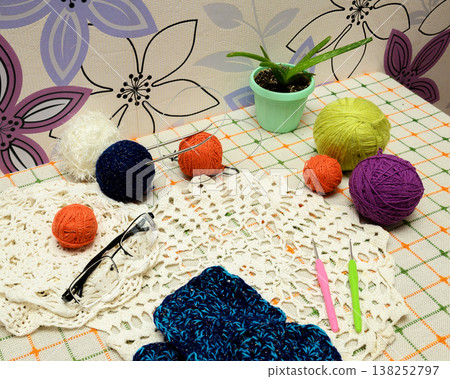 handicraft tools and bright yarn on a light table handicraft tools and bright yarn on a light table 138252797