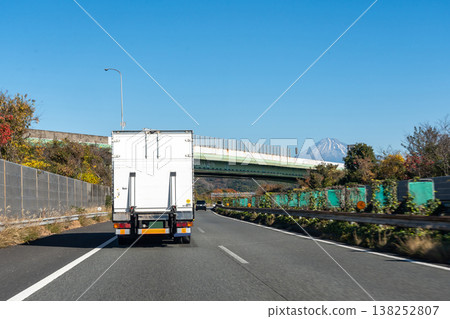 A truck driving near the Shimizu Interchange on the Tomei Expressway in Shizuoka City, Shizuoka Prefecture, with a view of Mount Fuji. A truck driving near the Shimizu Interchange on the Tomei Expressway in Shizuoka City, Shizuoka Prefecture, with a view of Mount Fuji. 138252807