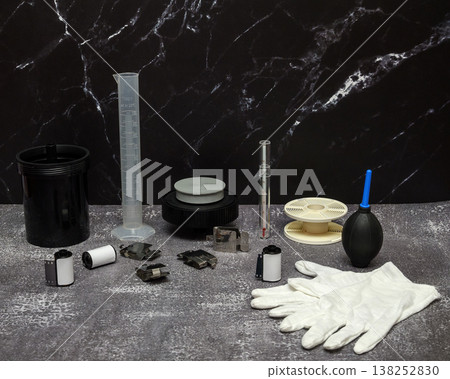 tools for developing photographic film with a reel and air blower on a gray stone texture background tools for developing photographic film with a reel and air blower on a gray stone texture background 138252830
