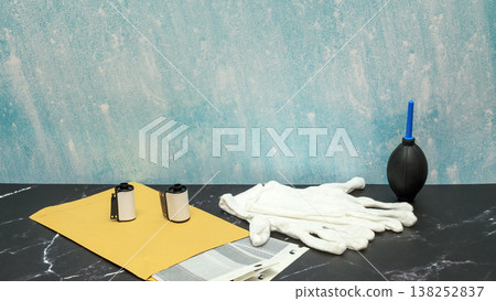 film developing kit with rolls white cotton gloves and rubber air blower on dark marble table surface film developing kit with rolls white cotton gloves and rubber air blower on dark marble table surface 138252837