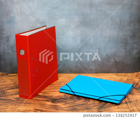red lever arch folder and blue organizer on table red lever arch folder and blue organizer on table 138252917