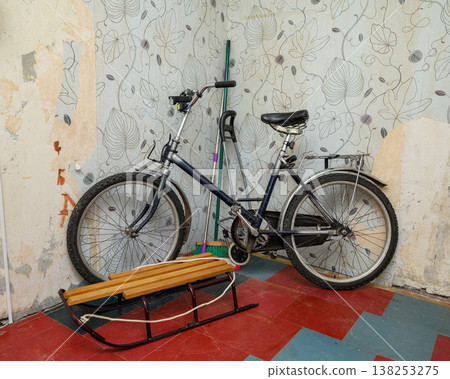 old bicycle and wooden sled in the corner of a room old bicycle and wooden sled in the corner of a room 138253275
