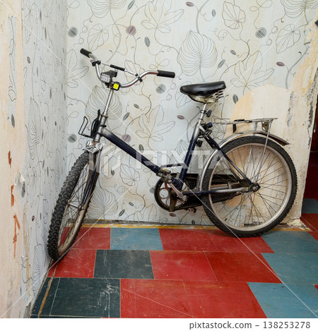 blue folding bike in the interior of an old hallway blue folding bike in the interior of an old hallway 138253278