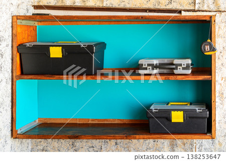 tool boxes on a wooden shelf 138253647