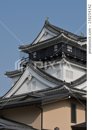 A close-up view of Okazaki Castle's keep against the sky and the beauty of its tiled roof. A close-up view of Okazaki Castle's keep against the sky and the beauty of its tiled roof. 138254142