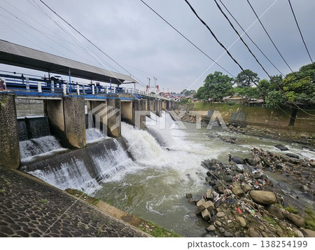An aerial drone perspective reveals the historic Katulampa Dam spanning the Ciliwung River in Bogor 138254199
