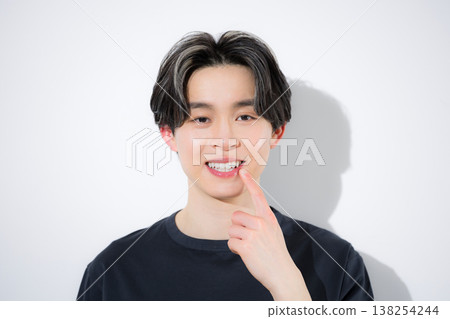 Close-up shots of young men looking directly at the camera, showing their mouths, lips, teeth alignment and whitening, and skincare. Close-up shots of young men looking directly at the camera, showing their mouths, lips, teeth alignment and whitening, and skincare. 138254244