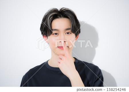 Close-up of a young man looking directly at the camera, showing his concern for nose skincare. Close-up of a young man looking directly at the camera, showing his concern for nose skincare. 138254246