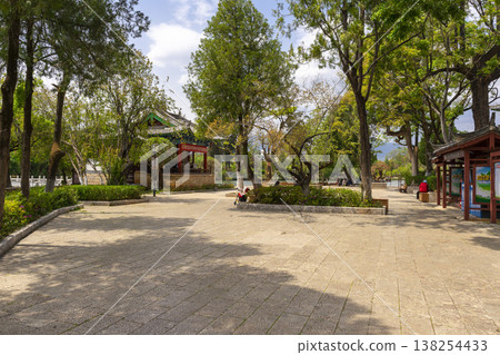 Lijiang, China - April 12, 2024 : : People enjoy weather at Black Dragon Pool Park in Dayan old town in Lijiang Old Town, China on April 12, 2024. 138254433