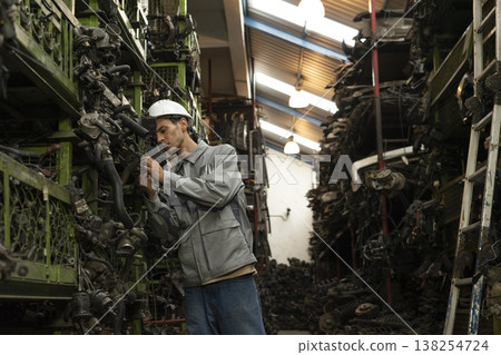 Technician worker working and checking in garage scrap yard car workshop warehouse. Technician worker working and checking in garage scrap yard car workshop warehouse. 138254724