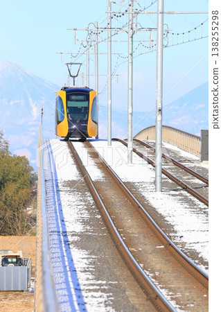 A train running through the snow: Utsunomiya Light Rail, Tobiyama Castle Ruins Station A train running through the snow: Utsunomiya Light Rail, Tobiyama Castle Ruins Station 138255298