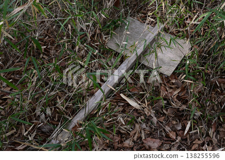 A sign that has fallen over in the bushes A sign that has fallen over in the bushes 138255596