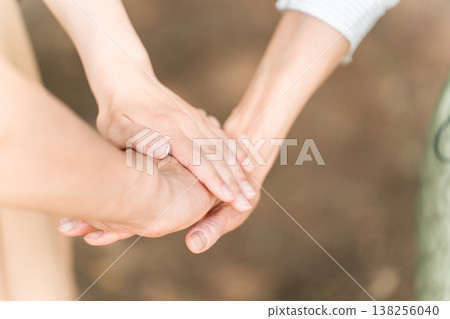Friends, families, and friends standing together in a circle at a campsite Friends, families, and friends standing together in a circle at a campsite 138256040