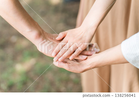 Friends, families, and friends standing together in a circle at a campsite Friends, families, and friends standing together in a circle at a campsite 138256041