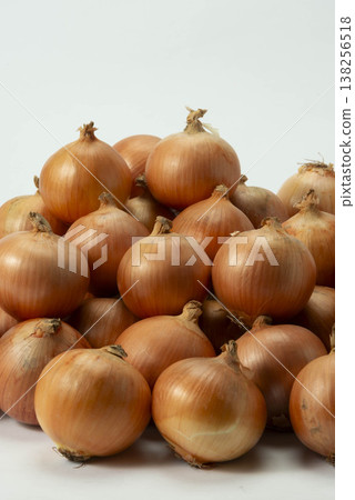 A pile of onions against a white background A pile of onions against a white background 138256518