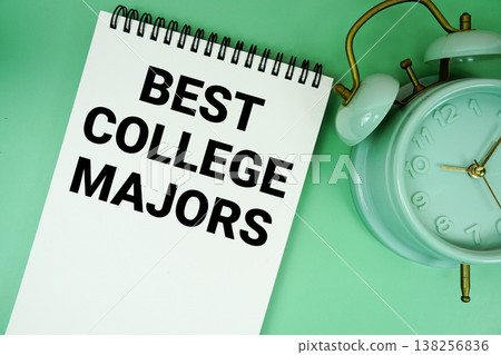 Best College Majors text with alarm clock flat lay on green background 138256836