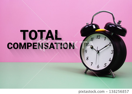 Black alarm clock on a pastel green and pink background with the text "Total Compensation" 138256857