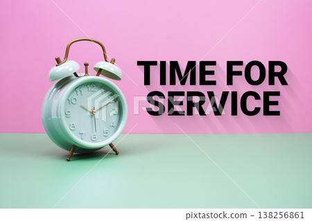 Black alarm clock on a pastel green and pink background with the text "Time For Service" Black alarm clock on a pastel green and pink background with the text "Time For Service" 138256861