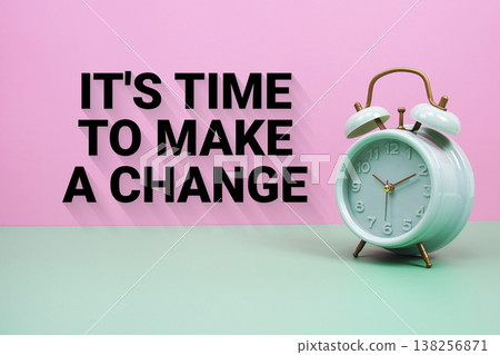 Black alarm clock on a pastel green and pink background with the text "It's Time To Make A Change" 138256871