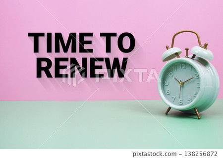 Black alarm clock on a pastel green and pink background with the text "Time To Renew" 138256872