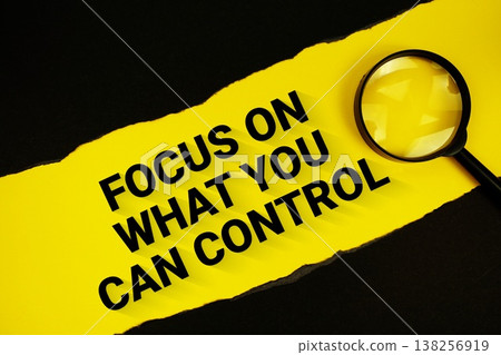 Focus On What You Can Control text on yellow with black paper torn ripped and magnifying glass Focus On What You Can Control text on yellow with black paper torn ripped and magnifying glass 138256919