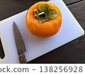 Persimmon on a cutting board 138256928