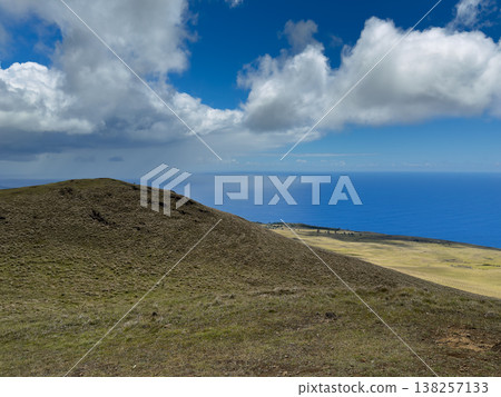 A panoramic view of the Pacific Ocean and grasslands from the summit of Mount Televaka on Easter Island. A panoramic view of the Pacific Ocean and grasslands from the summit of Mount Televaka on Easter Island. 138257133