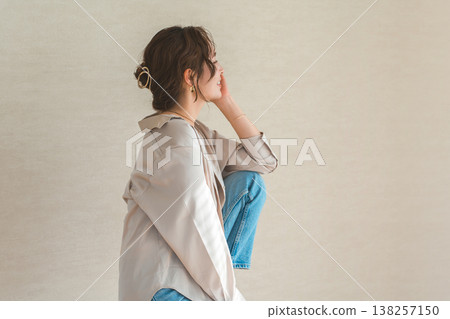 高腳椅,身穿牛仔服的女模特兒坐在椅子上 高腳椅,身穿牛仔服的女模特兒坐在椅子上 138257150