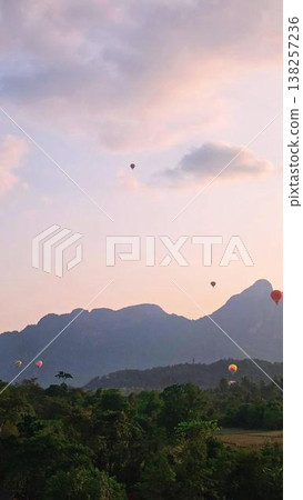 Looking at the rising hot air balloon  138257236