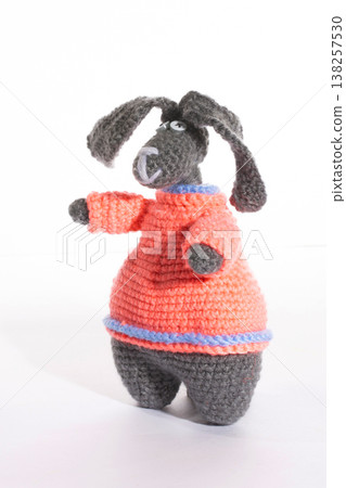 A funny rabbit crocheted from wool on a white background A funny rabbit crocheted from wool on a white background 138257530