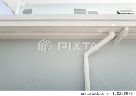Gutter and downspout on the building 138258976