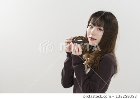 A woman eating a donut A woman eating a donut 138259358
