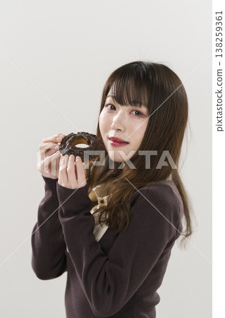 A woman eating a donut A woman eating a donut 138259361