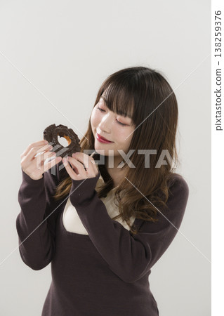 A woman eating a donut 138259376