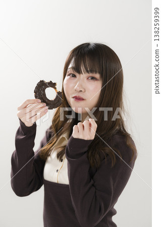 A woman eating a donut A woman eating a donut 138259399