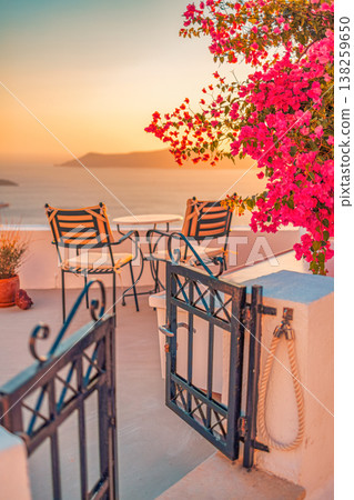 Fantastic romance honeymoon destination Santorini Greece, gorgeous sunset, flowers, sunlight, chairs overlooking caldera sea view Fantastic romance honeymoon destination Santorini Greece, gorgeous sunset, flowers, sunlight, chairs overlooking caldera sea view 138259650