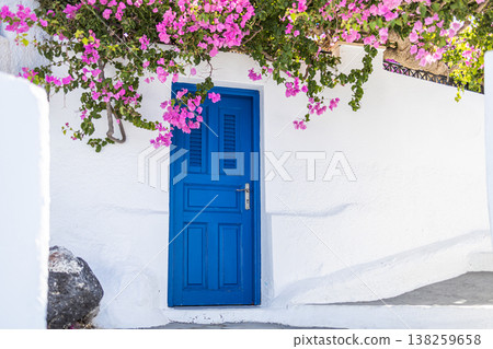 Romantic Santorini panorama with blue doors, pink flowers, and white buildings, dreamy summer travel tourism street view Romantic Santorini panorama with blue doors, pink flowers, and white buildings, dreamy summer travel tourism street view 138259658