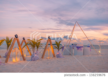 Tropical beach destination wedding setup with candles, flowers, and table chairs, radiant romantic honeymoon background Tropical beach destination wedding setup with candles, flowers, and table chairs, radiant romantic honeymoon background 138259676