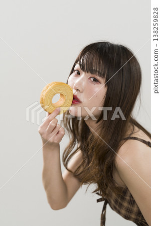 A woman holding a Baumkuchen A woman holding a Baumkuchen 138259828