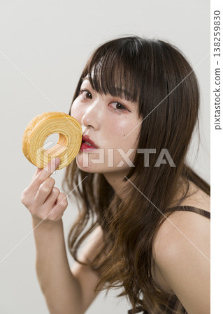 A woman holding a Baumkuchen A woman holding a Baumkuchen 138259830