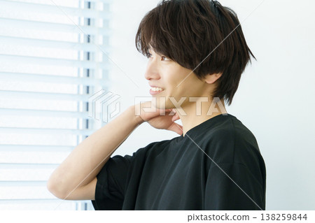 Portrait of a young Japanese man standing by a window Portrait of a young Japanese man standing by a window 138259844