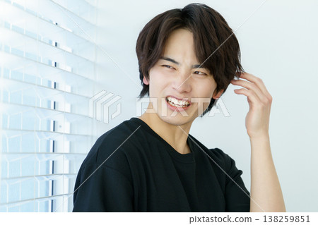 一幅年輕日本男子站在窗邊，神情憂慮的肖像畫。 138259851