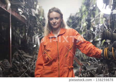 Technician female worker working in garage scrap yard old car part workshop warehouse. 138259878