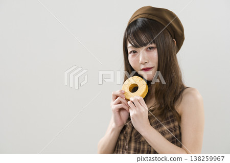 A woman holding a Baumkuchen A woman holding a Baumkuchen 138259967