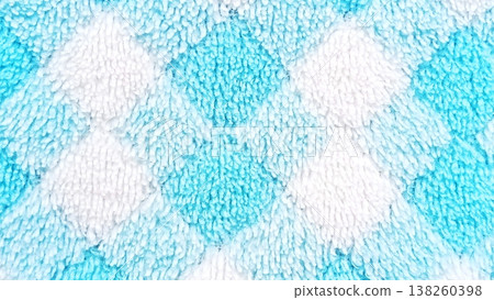 Close-up of a soft and fluffy fabric featuring a charming argyle diamond pattern in vibrant blue and pristine white. Ideal for backgrounds, textiles, and cozy themes. Close-up of a soft and fluffy fabric featuring a charming argyle diamond pattern in vibrant blue and pristine white. Ideal for backgrounds, textiles, and cozy themes. 138260398