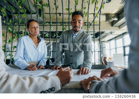 Business representatives engaged in contract negotiations Business representatives engaged in contract negotiations 138260436