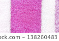 Close-up view of a soft, absorbent terry cloth towel featuring vibrant pink and white stripes. Ideal for backgrounds, textiles, and design projects. 138260483
