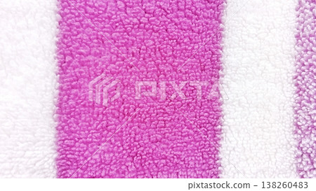 Close-up view of a soft, absorbent terry cloth towel featuring vibrant pink and white stripes. Ideal for backgrounds, textiles, and design projects. Close-up view of a soft, absorbent terry cloth towel featuring vibrant pink and white stripes. Ideal for backgrounds, textiles, and design projects. 138260483