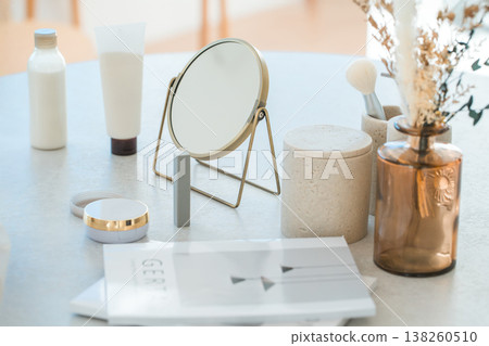 Makeup tools, cosmetics, makeup, and a tabletop mirror on the table 138260510